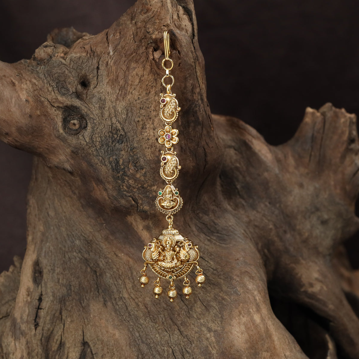 Signature Lakshmi Tikka with intricate circular elements and a richly detailed pendant