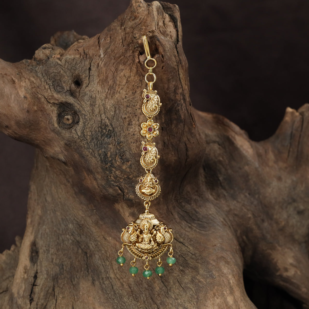 Signature Lakshmi Tikka with intricate circular elements and a richly detailed pendant