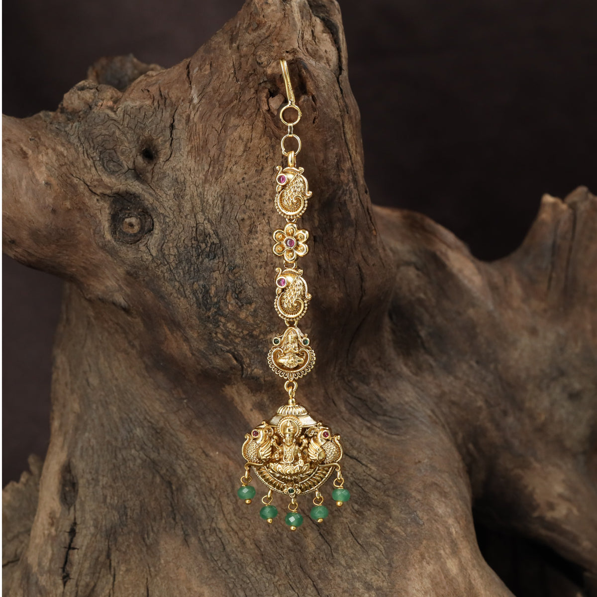 Signature Lakshmi Tikka with intricate circular elements and a richly detailed pendant