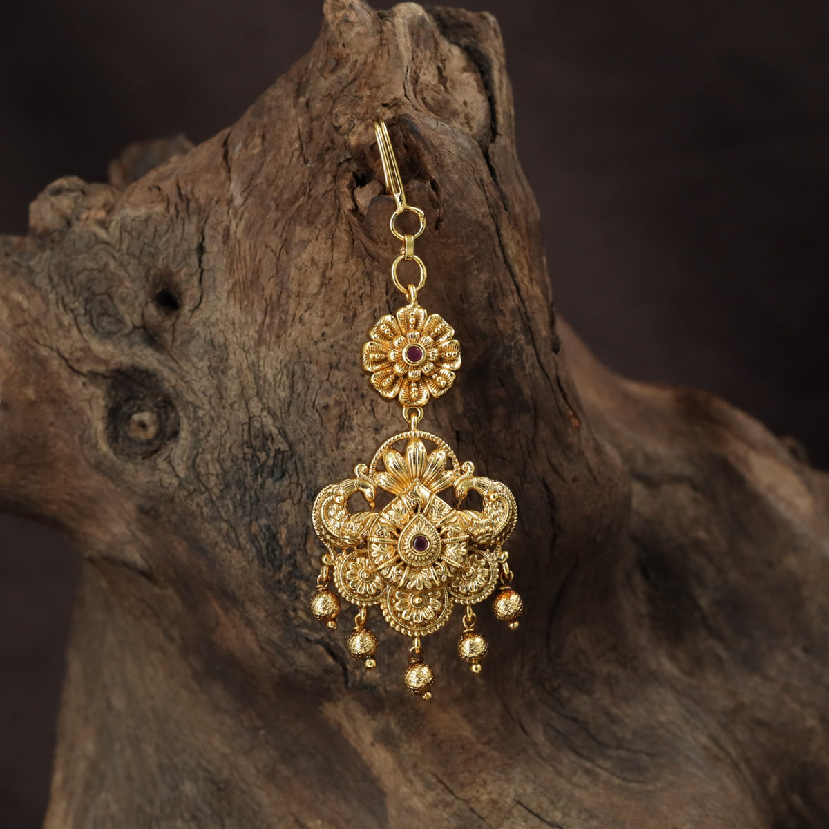 Regal peacock Tikka with ornate floral detailing and graceful hanging drops