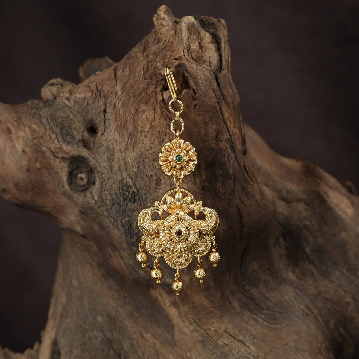 Regal peacock Tikka with ornate floral detailing and graceful hanging drops