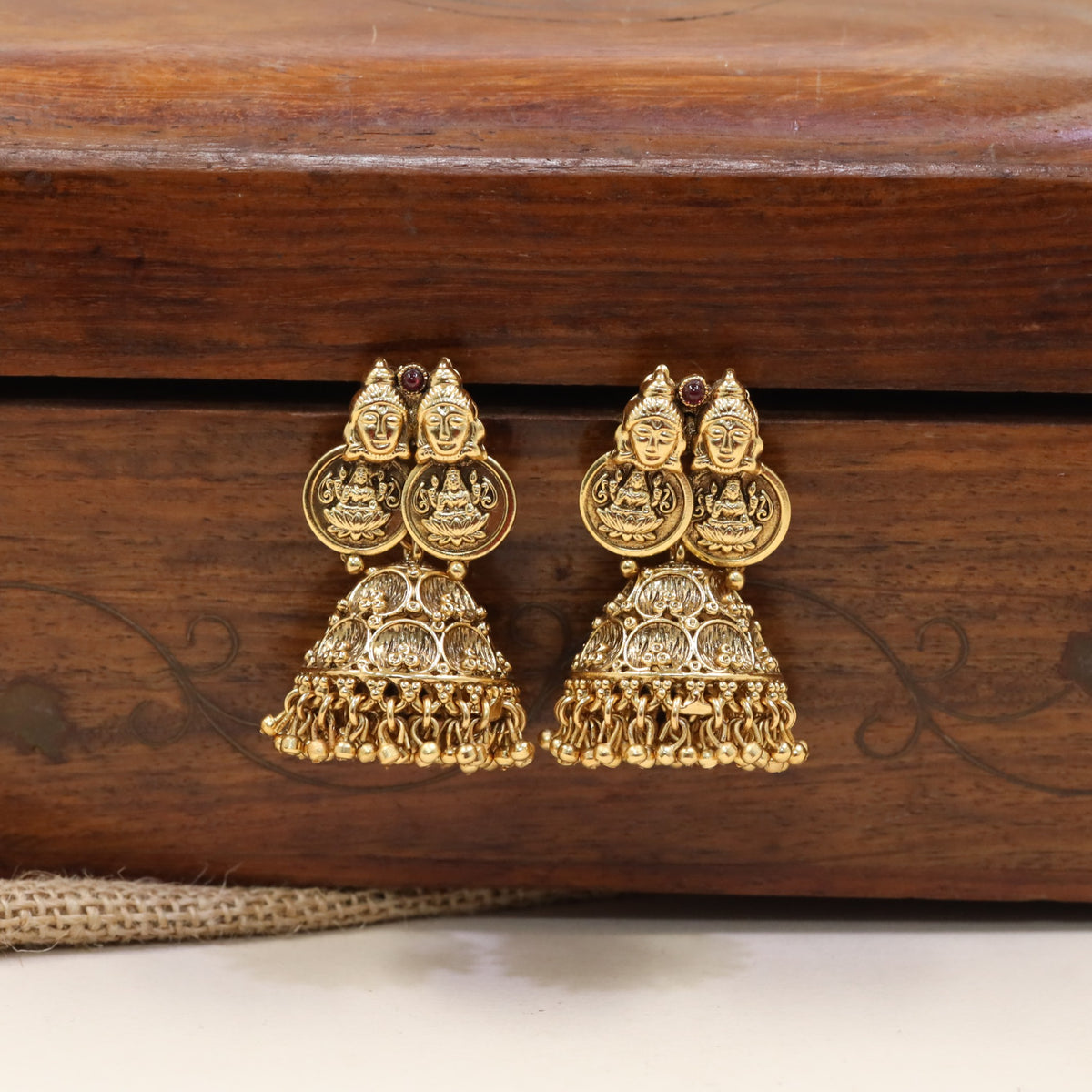 Lakshmi Jumka featuring sculpted goddess faces and traditional coin accents