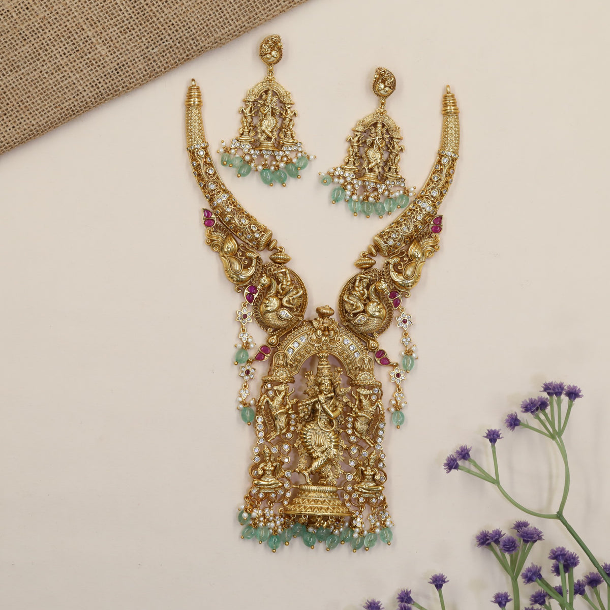 A grand Krishna Necklace framed by sculpted peacocks and traditional detailing