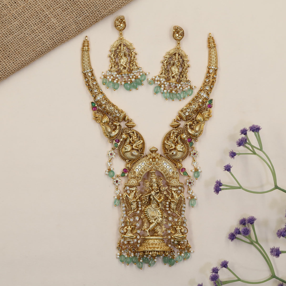A grand Krishna Necklace framed by sculpted peacocks and traditional detailing