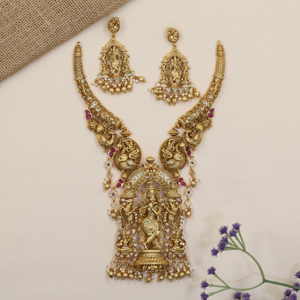 A grand Krishna Necklace framed by sculpted peacocks and traditional detailing