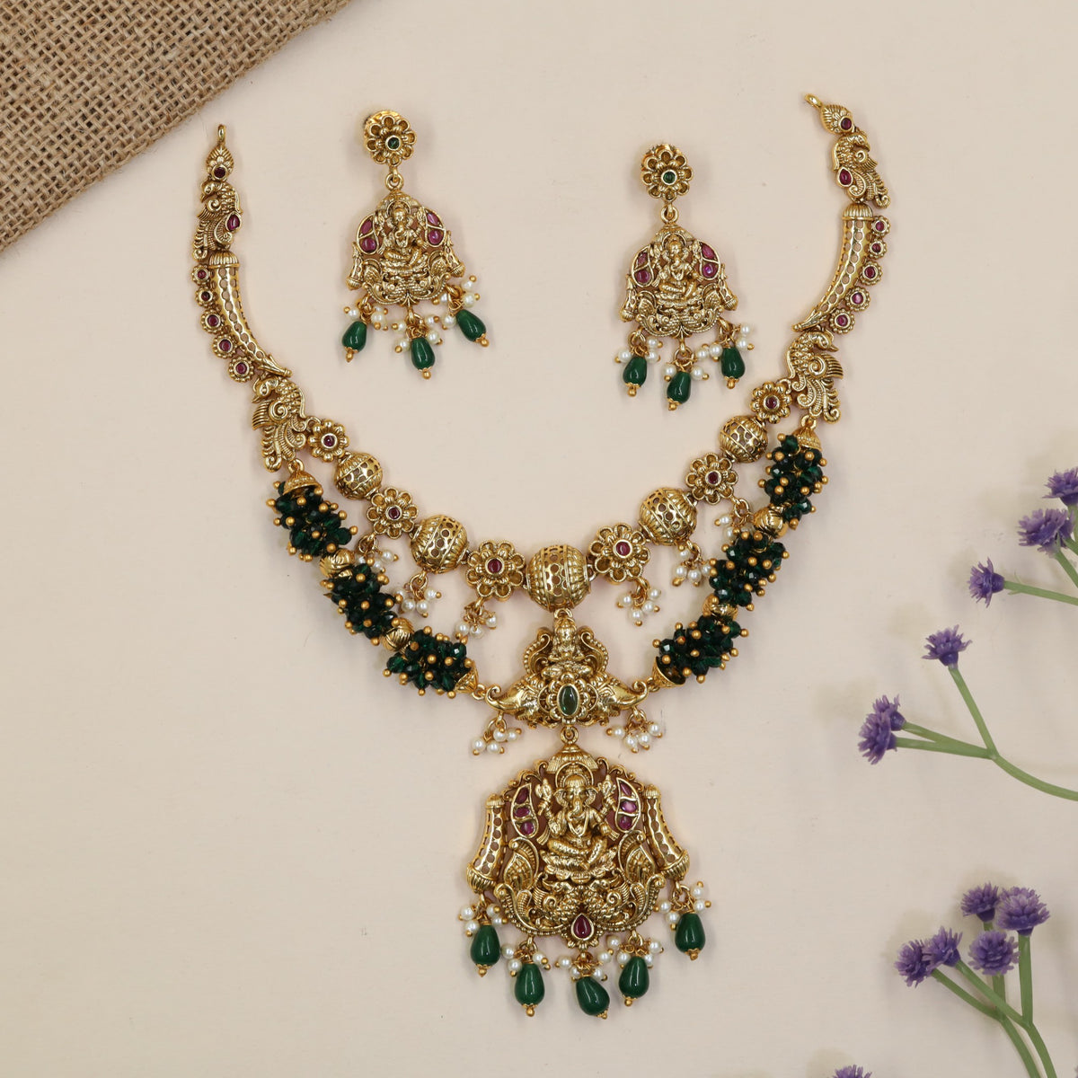 Vintage-inspired jewellery set showcasing Ganesha and symmetrical peacock artistry