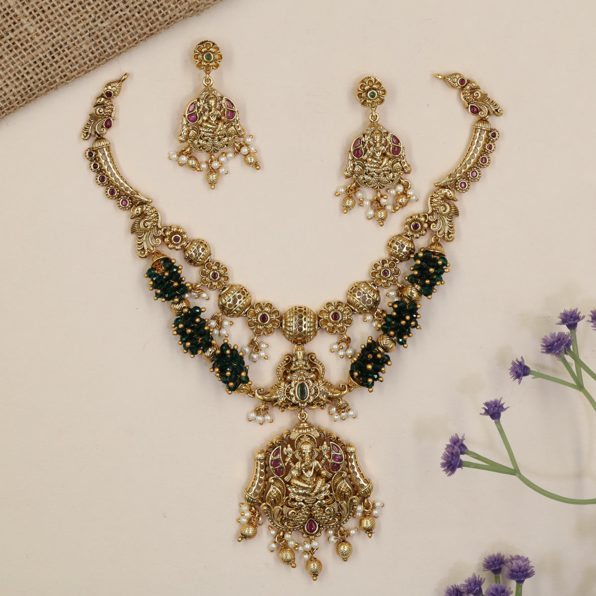 Vintage-inspired jewellery set showcasing Ganesha and symmetrical peacock artistry