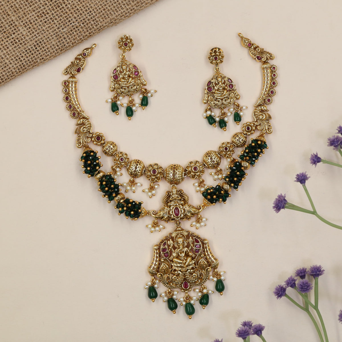 Vintage-inspired jewellery set showcasing Ganesha and symmetrical peacock artistry