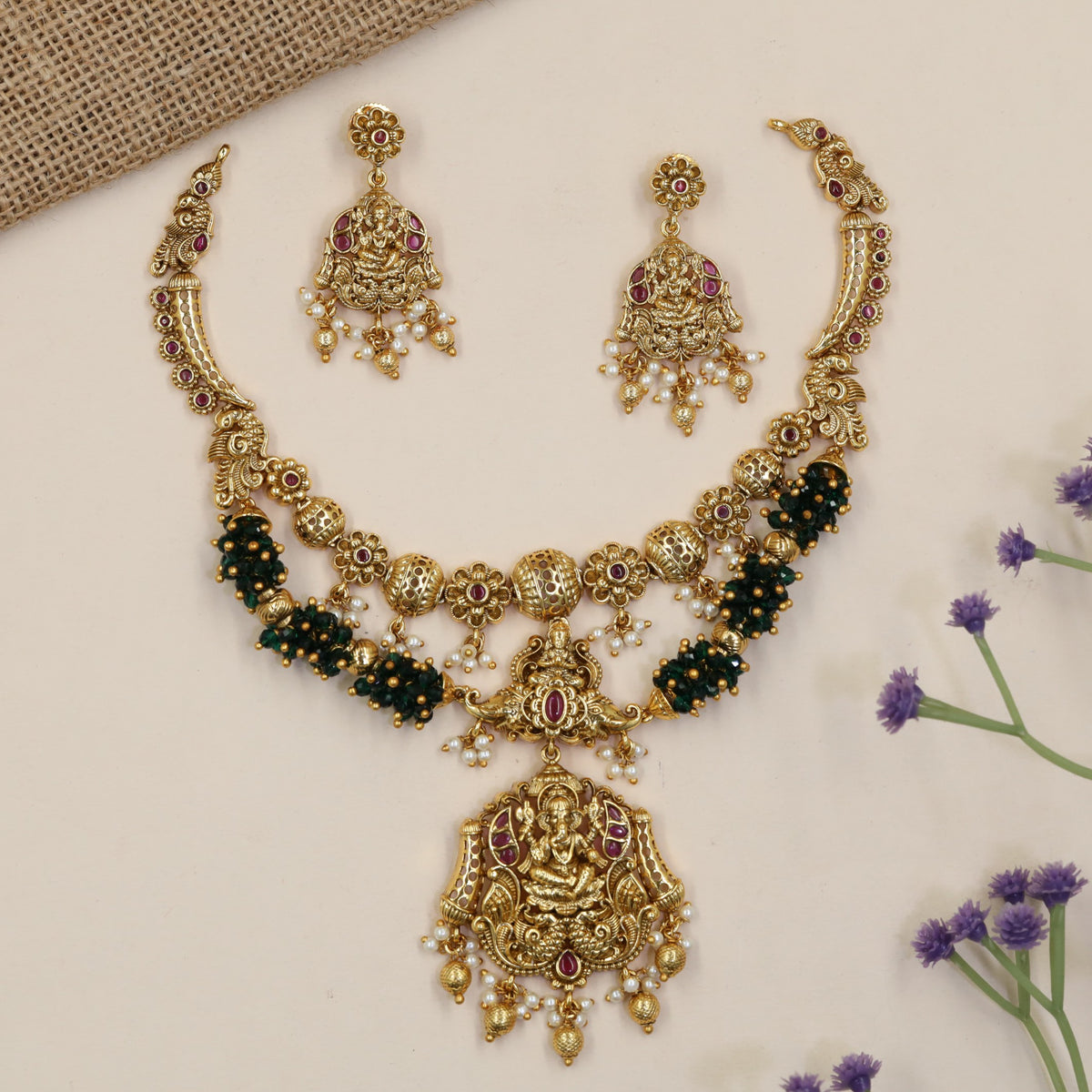 Vintage-inspired jewellery set showcasing Ganesha and symmetrical peacock artistry
