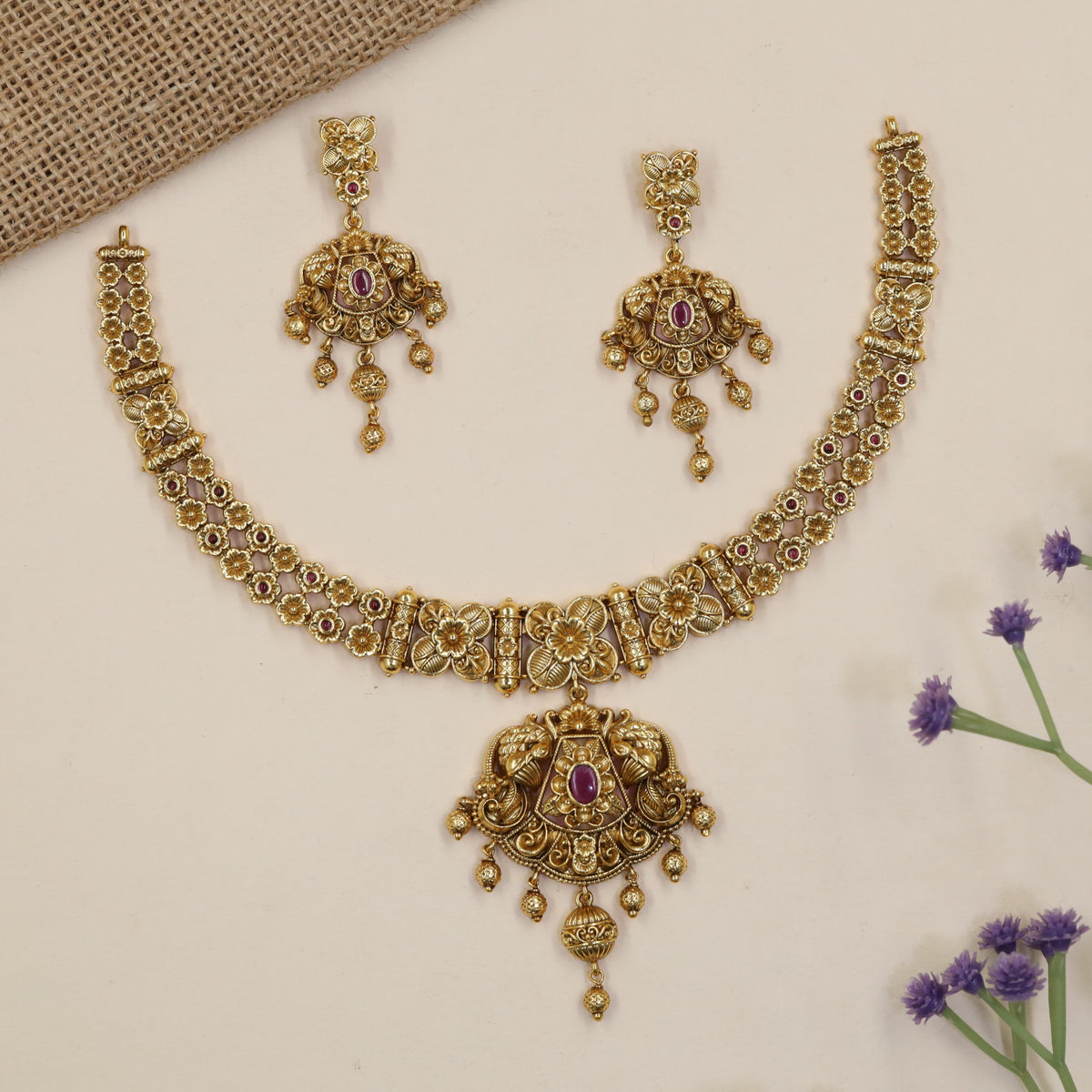 Heirloom-style Necklace showcasing intricate flowers, ornamental bars and a statement pendant