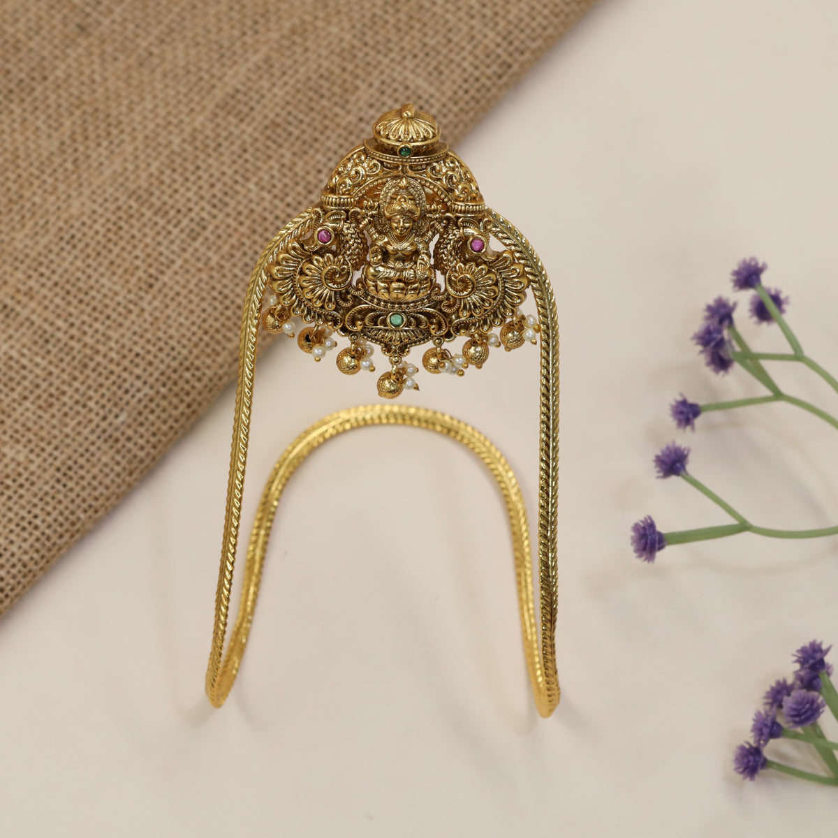 An elegant Antique Vanki centred on Lakshmi with ornate peacock detailing