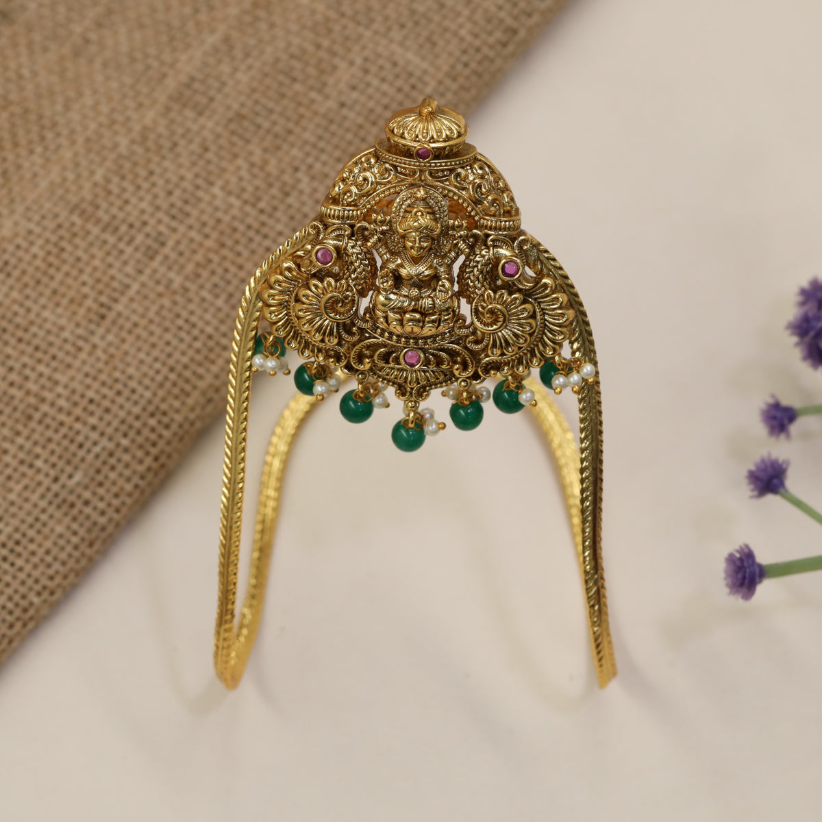 An elegant Antique Vanki centred on Lakshmi with ornate peacock detailing