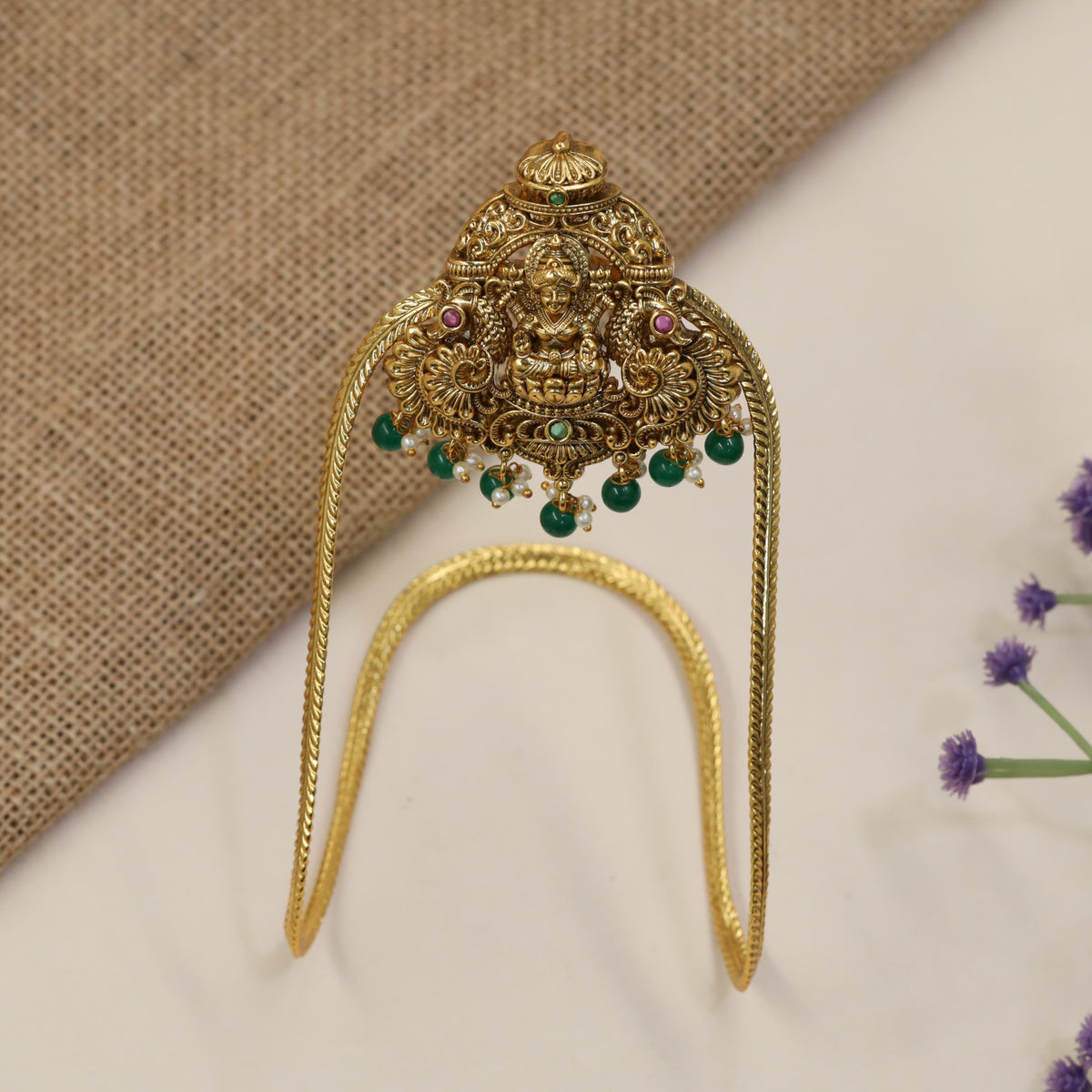 An elegant Antique Vanki centred on Lakshmi with ornate peacock detailing