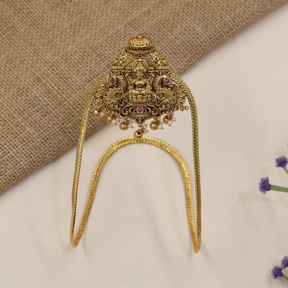An elegant Antique Vanki centred on Lakshmi with ornate peacock detailing