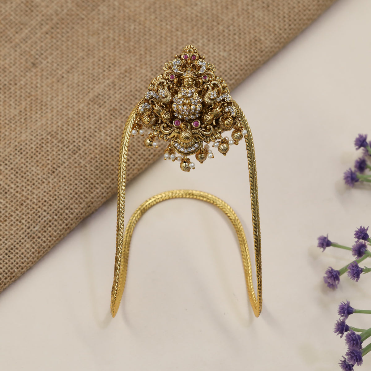 A heritage-inspired Vanki designed with detailed Lakshmi work and ornate borders