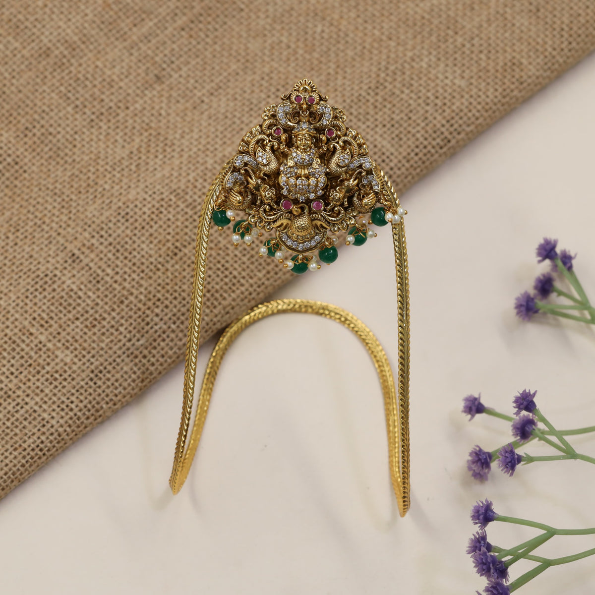A heritage-inspired Vanki designed with detailed Lakshmi work and ornate borders