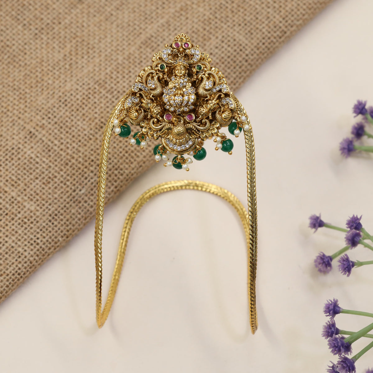 A heritage-inspired Vanki designed with detailed Lakshmi work and ornate borders