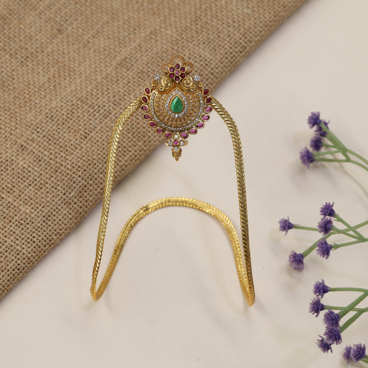 Signature Vanki featuring a floral crest, intricate scrollwork and refined traditional artistry