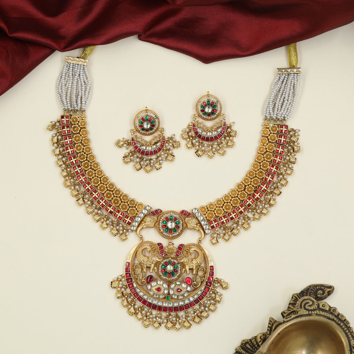 Jadau Necklace bringing together sculpted elephants, peacock forms and ornamental fringe