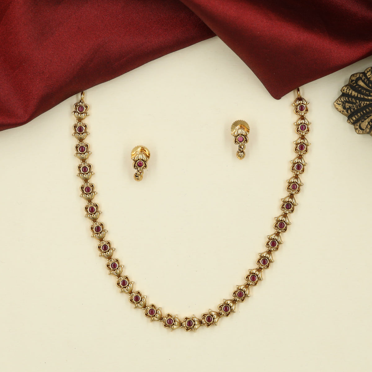Traditional Necklace with Repeating Round Accents and Intricate Decorative Links
