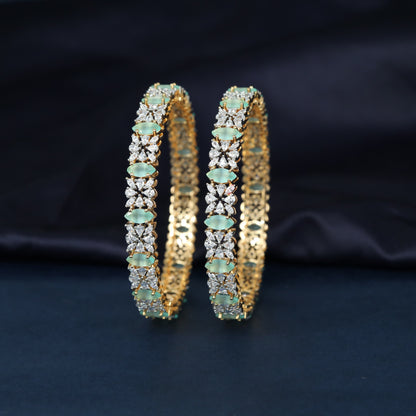 Gj Bangles designed with alternating oval elements and delicate flower shaped clusters