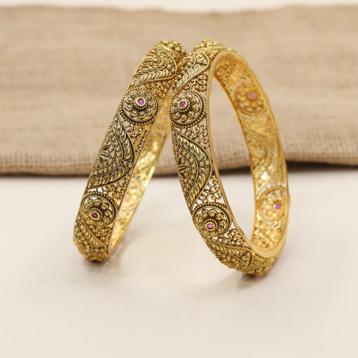 Antique Bangles with floral rosettes and decorative paisley elements