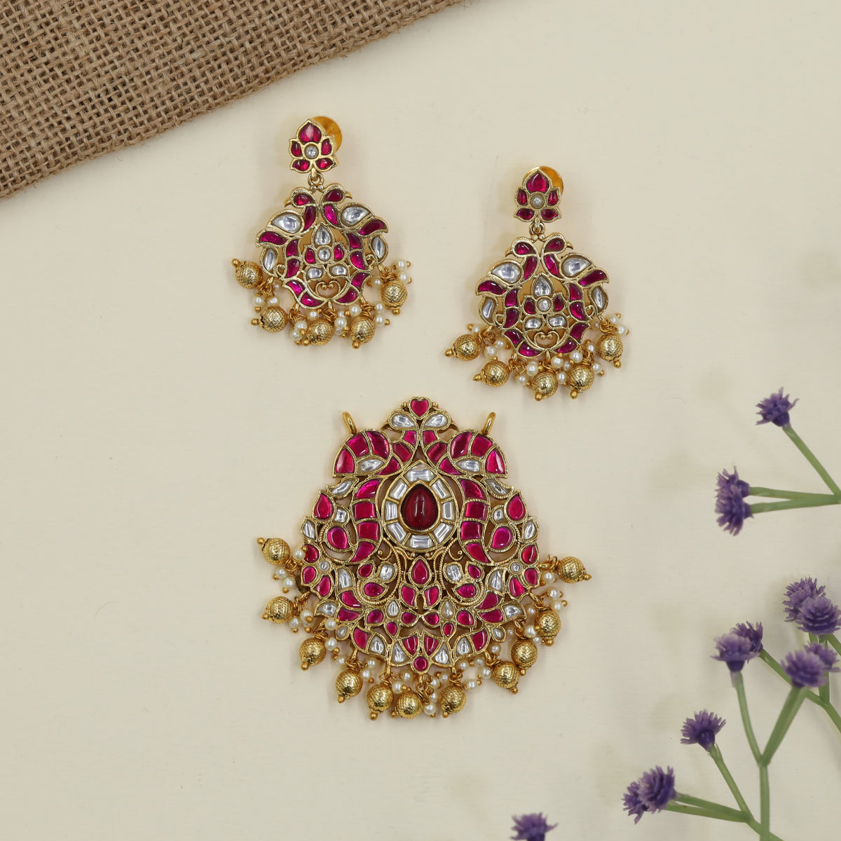 Jadau Pendant with decorative hanging elements and peacock inspired earrings