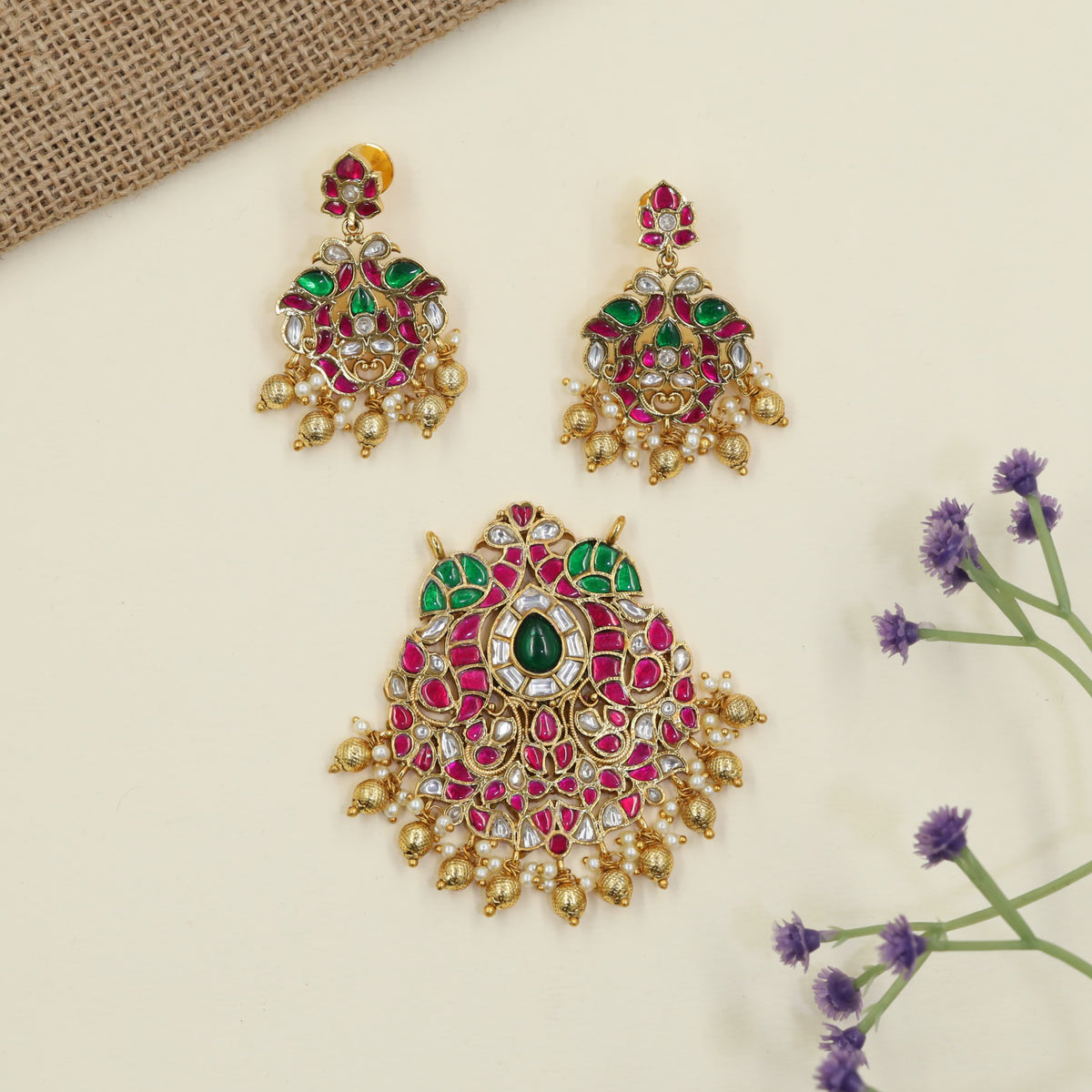 Jadau Pendant with decorative hanging elements and peacock inspired earrings
