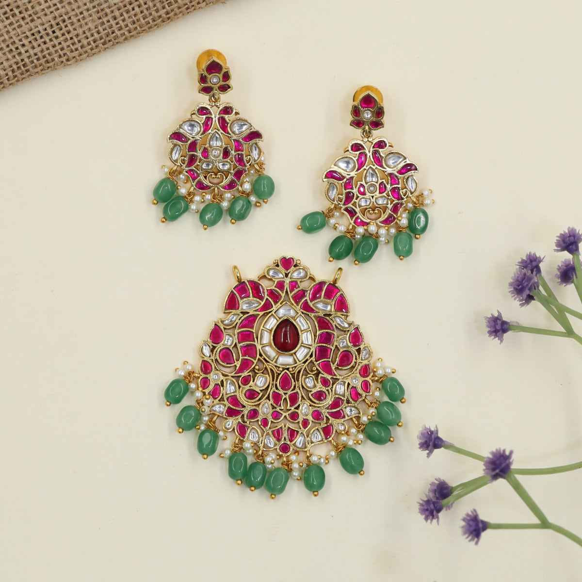 Jadau Pendant with decorative hanging elements and peacock inspired earrings
