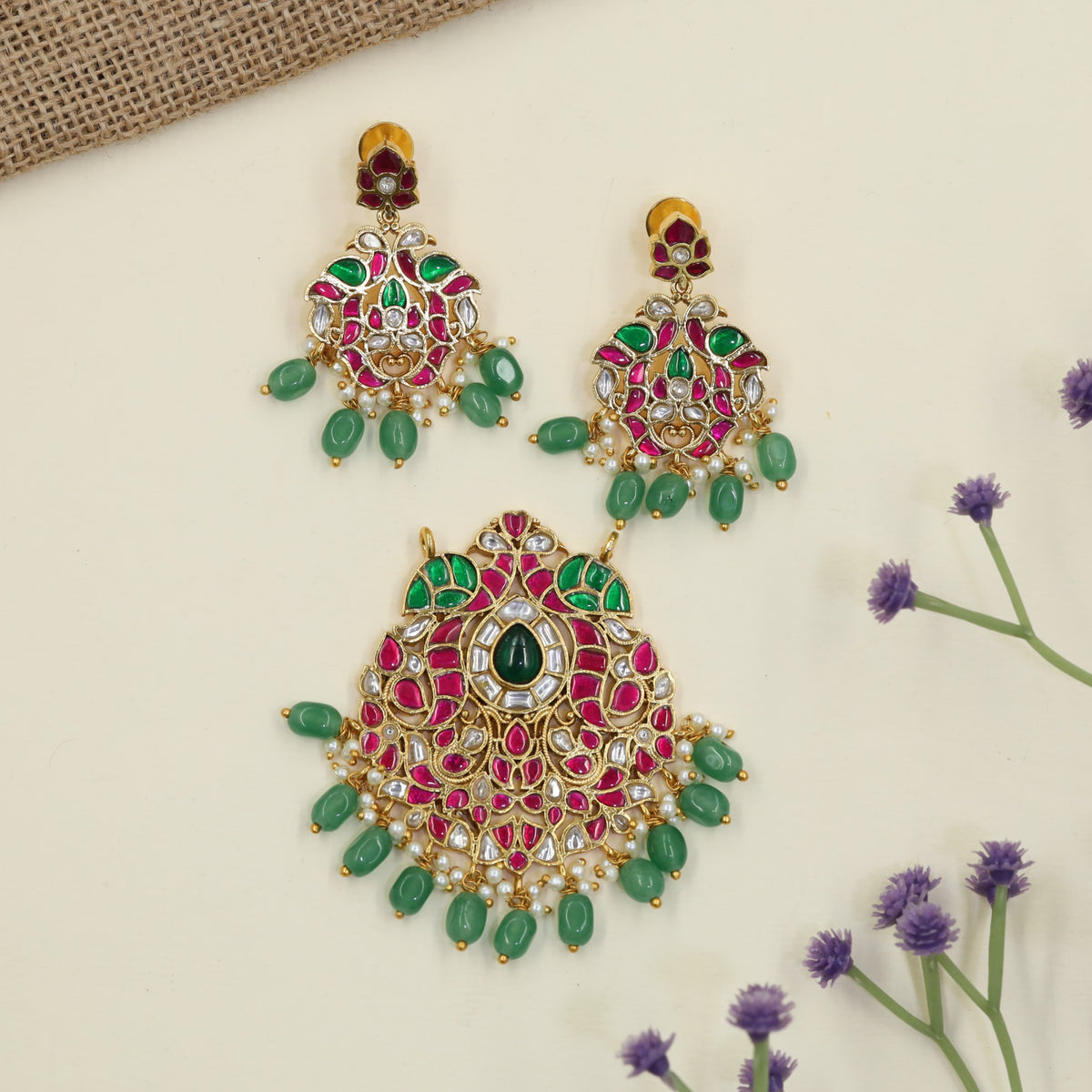 Jadau Pendant with decorative hanging elements and peacock inspired earrings