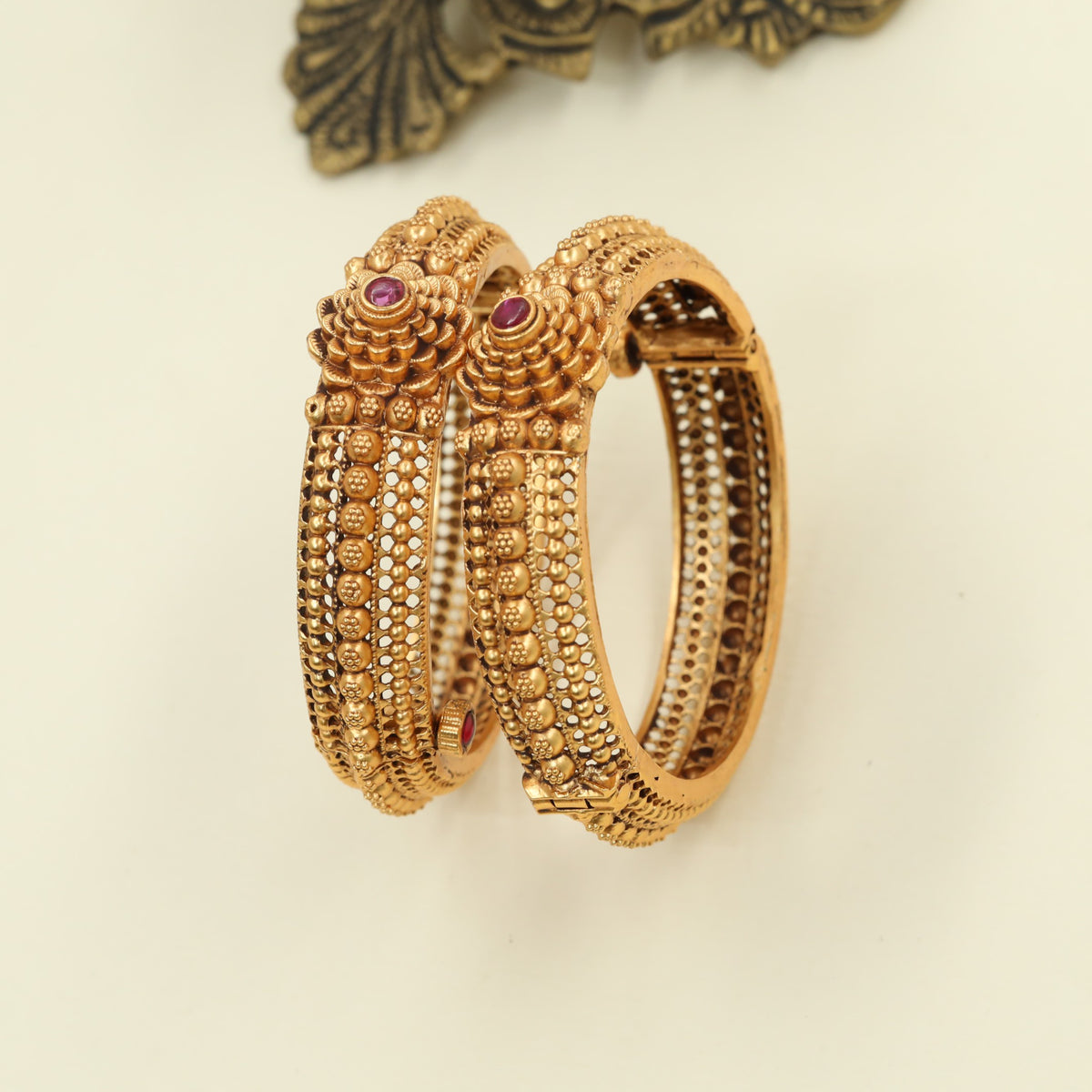 Antique Bangles featuring sculpted floral sections and beaded borders