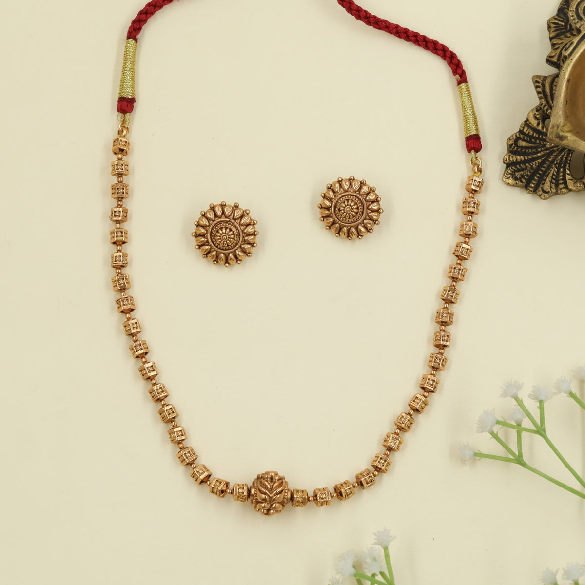Antique beads necklace with ornate central bead design
