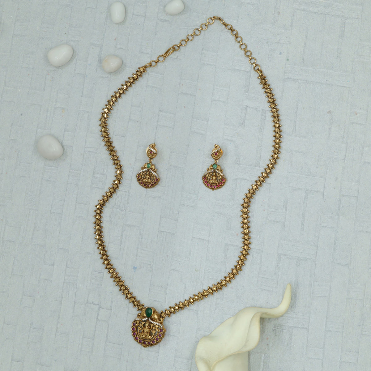 Rounded Lakshmi pendant with delicate hanging accents