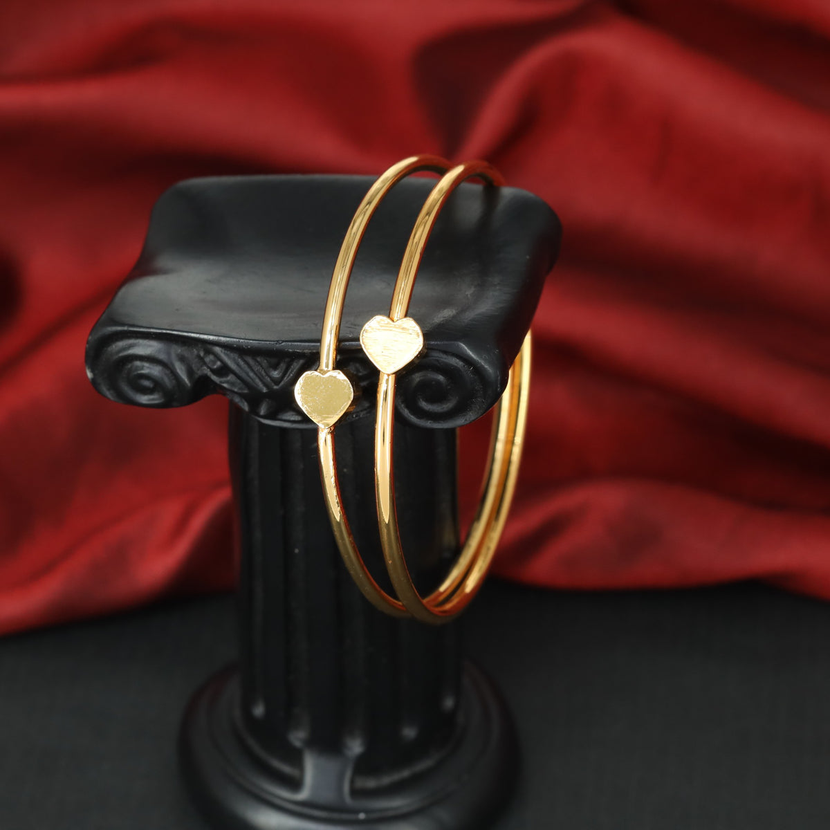 Delicate gold bangles with elegant heart shaped elements