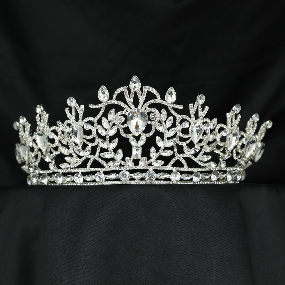 A graceful Crown showcasing curling vines, delicate leaves and an elevated centre