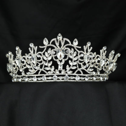 A graceful Crown showcasing curling vines, delicate leaves and an elevated centre