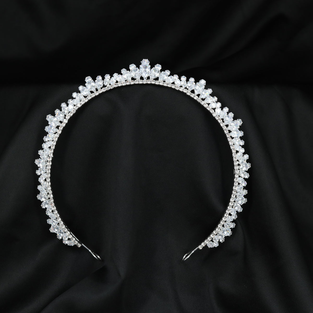 Signature Crown crafted with intricate openwork patterns and a prominent raised centre detail