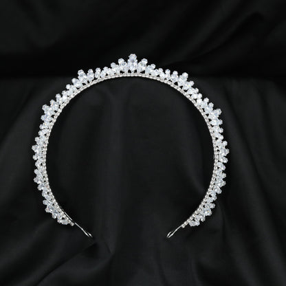 Signature Crown crafted with intricate openwork patterns and a prominent raised centre detail