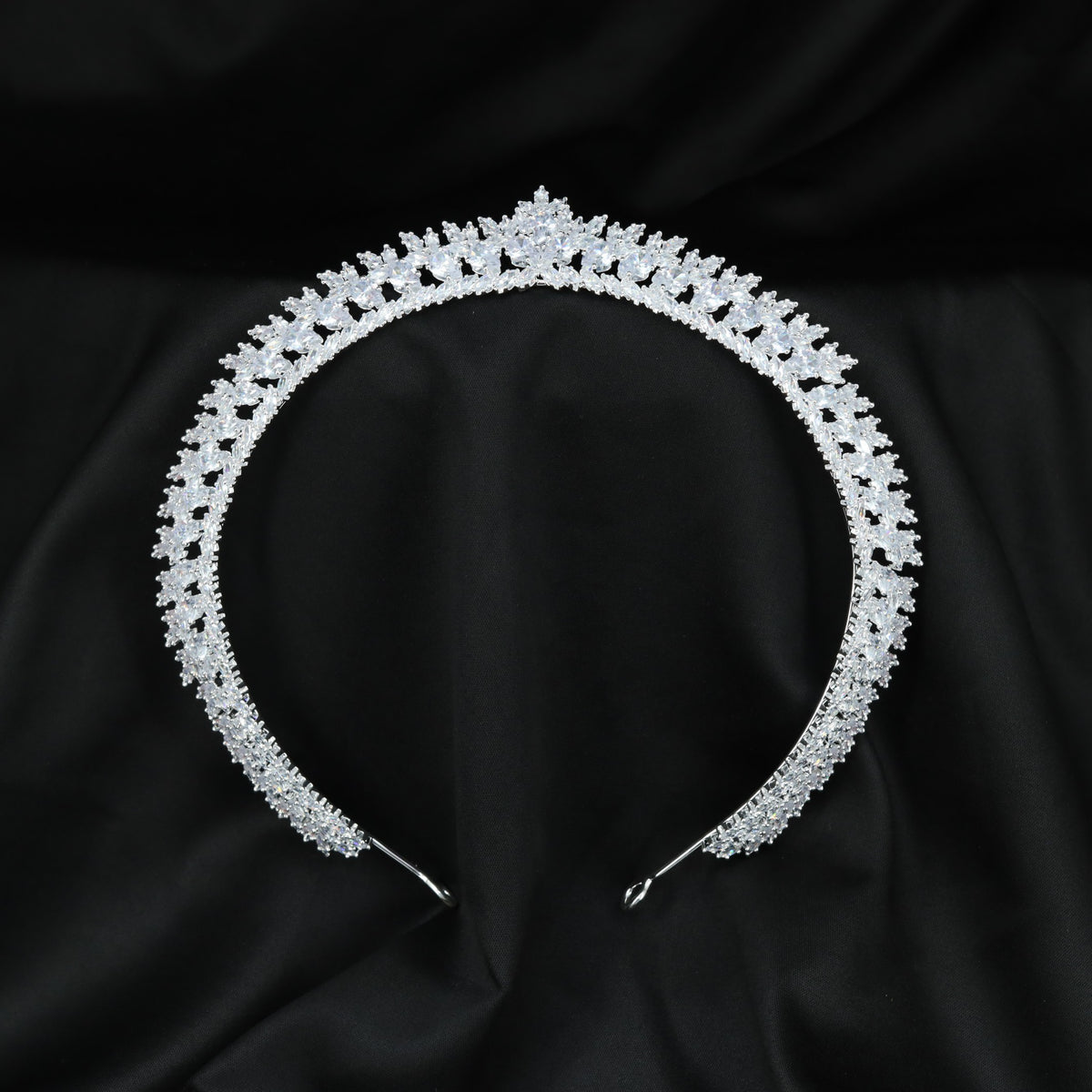 Royal Crown featuring a curved openwork band with repeating leaf-like accents