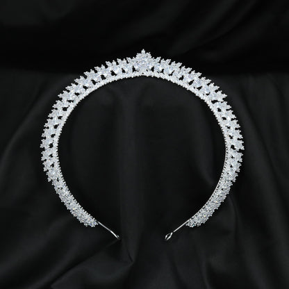 Royal Crown featuring a curved openwork band with repeating leaf-like accents