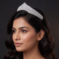 Luxurious fan shaped crown with closely arranged detailing and a refined raised centre