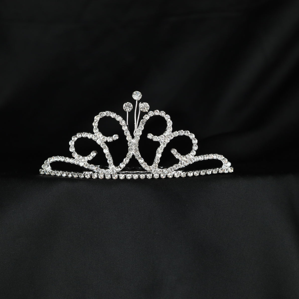 Classic ornamental crown with symmetrical scrollwork and delicate central accents