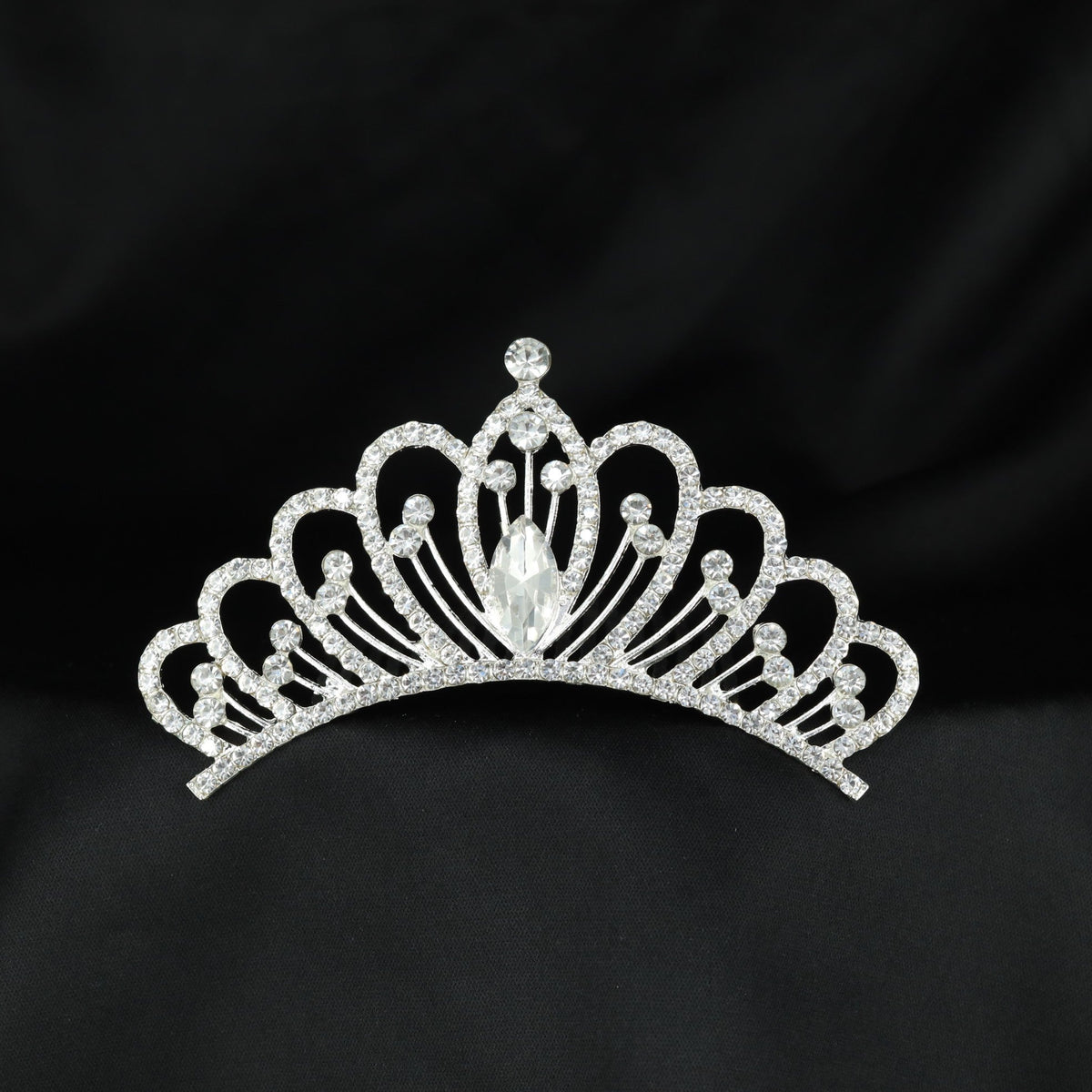 Graceful crystal crown with repeated curved arches and a prominent centre accent