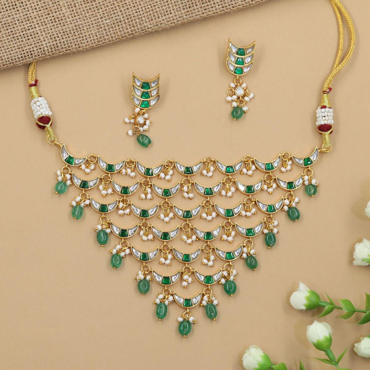 Traditional jadau choker with graduated crescent links and delicate bead drops