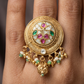Circular disc kundan finger ring with carved radial layers and floral center cluster with drop fringe