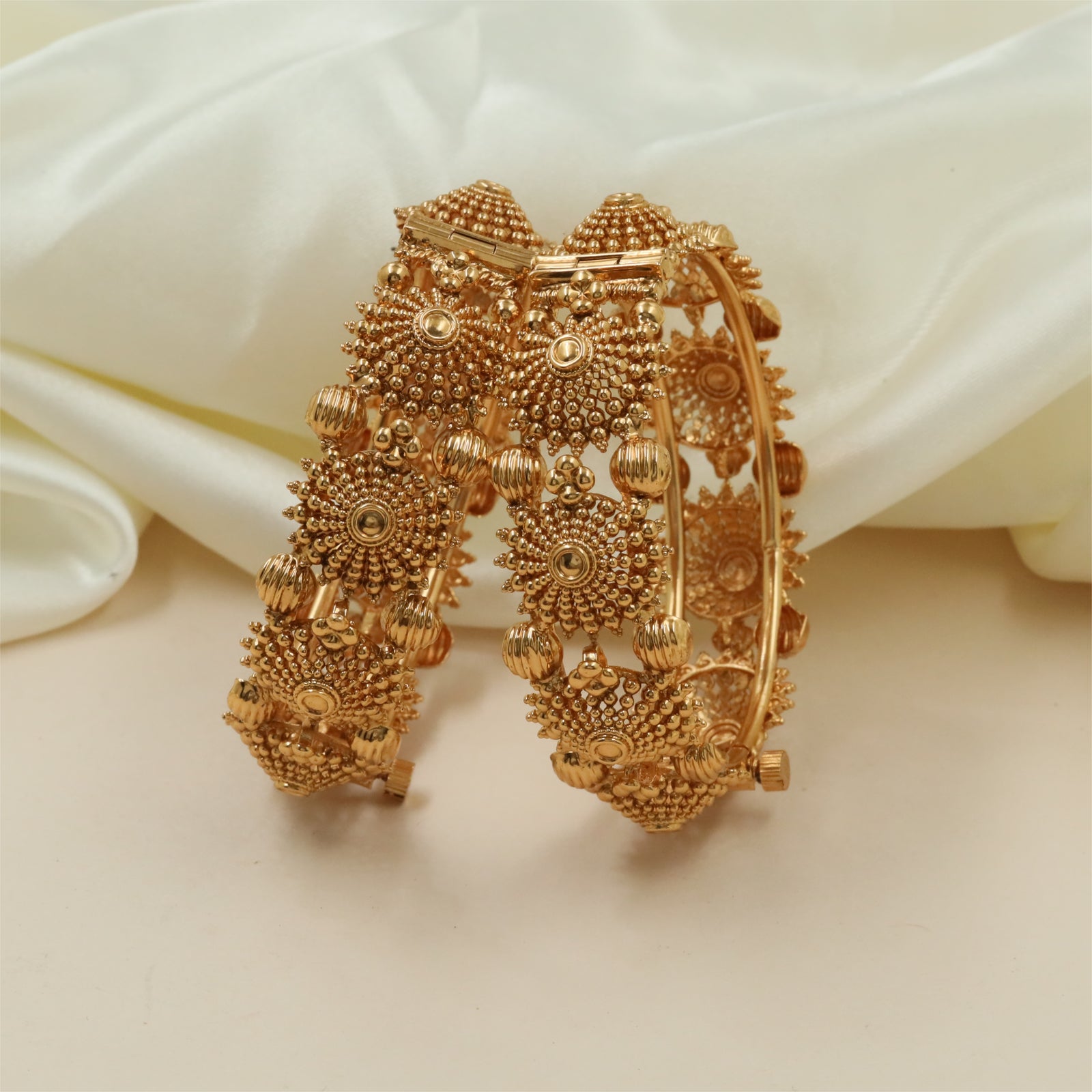 Royal circular motif bangles with structured carved frames