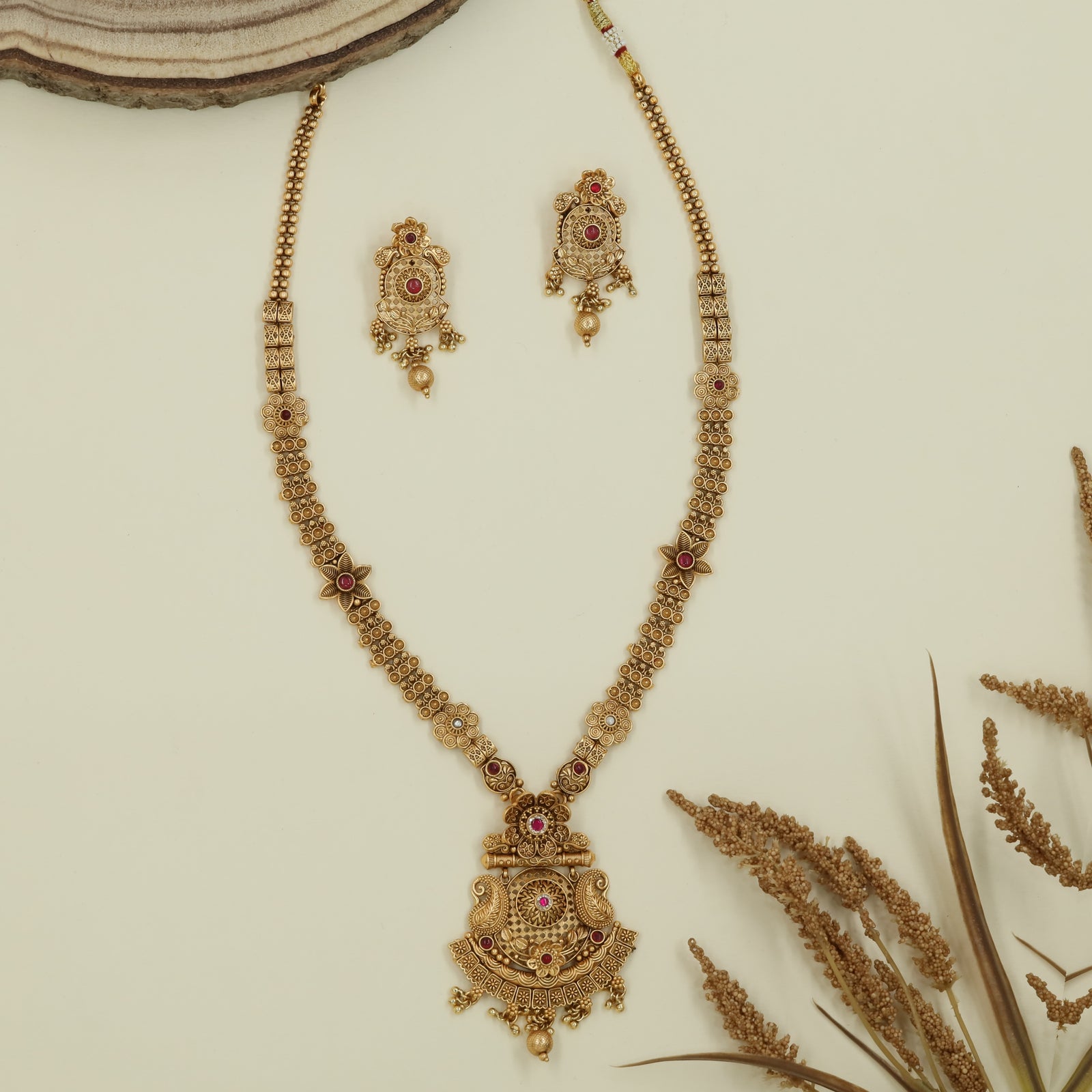 Floral panel long haara with spaced connectors and engraved pendant with drop elements