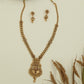 Intricate disc long haara with embossed links and wide drop pendant with central accent