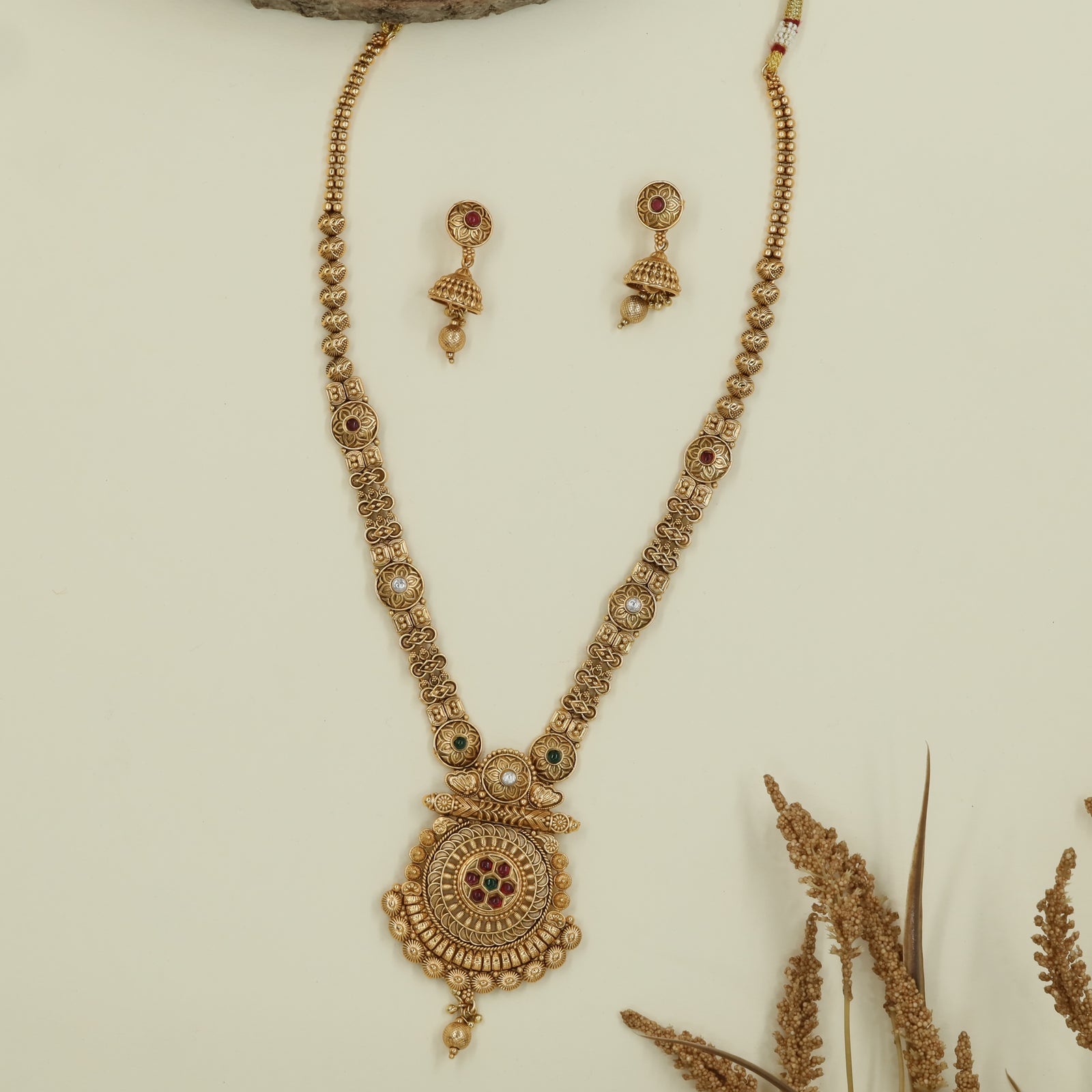 Granulated bead long haara with textured links and ornate medallion pendant with hanging drop