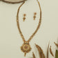 Floral link long haara with repeating disc sections and broad medallion pendant with bead hanging